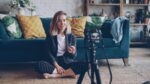 Woman recording video in a living room
