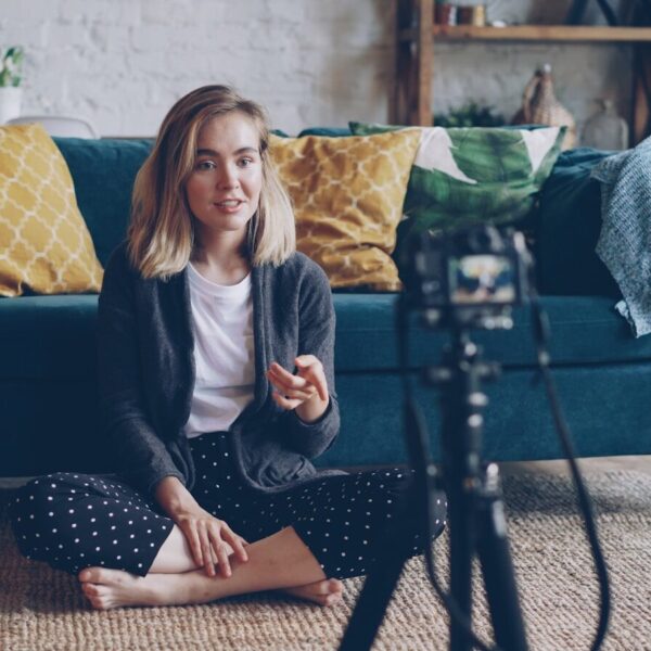 Woman recording video in a living room